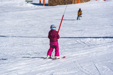 Pas de la Casa, Andorra: January 3, 2021: Mother with her Child skiing in the Pyrenees at the Grandvalira ski resort in Andorra in time of Covid19
