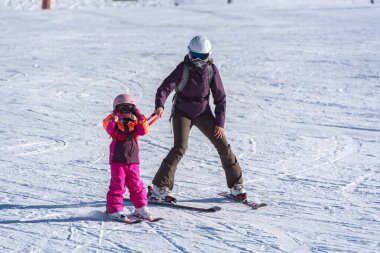 Pas de la Casa, Andorra: January 3, 2021: Mother with her Child skiing in the Pyrenees at the Grandvalira ski resort in Andorra in time of Covid19