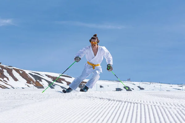 Skier dressed as a karateka at a ski station.