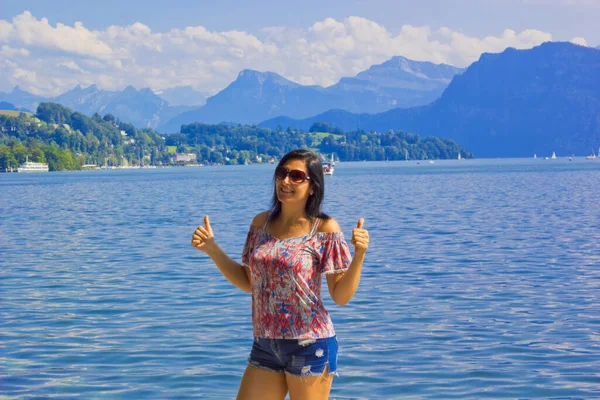 Happy woman looking at camera in lake luzern, Switzerland