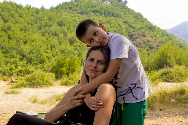 happy family smiling at camera in green nature