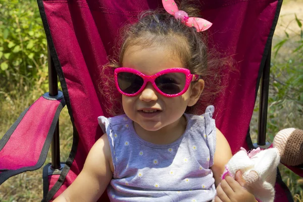 happy child in sunglasses smiling at camera