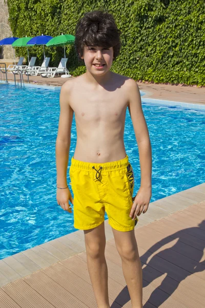 Happy boy is have fun in the swimming pool — Stock Fotó