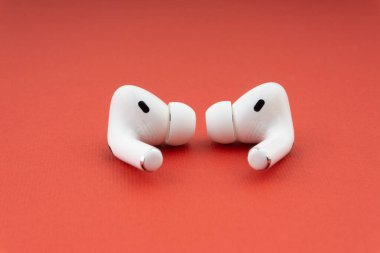Kuala Lumpur, Malaysia - December 1,2020 : AirPods Pro on red background clipart