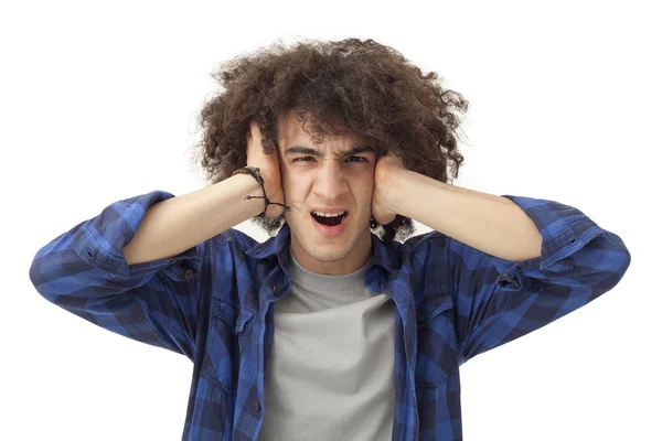 Furious young man covering ears with hands — Stock Photo, Image