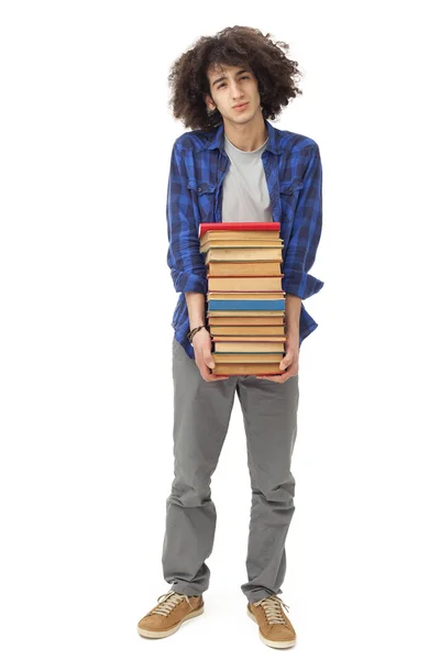 Studente di sesso maschile che trasporta libri pesanti — Foto Stock