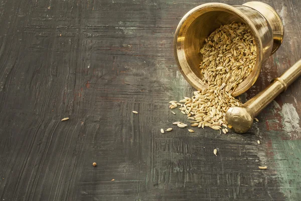 Cumin seeds on wooden background — Stock Photo, Image