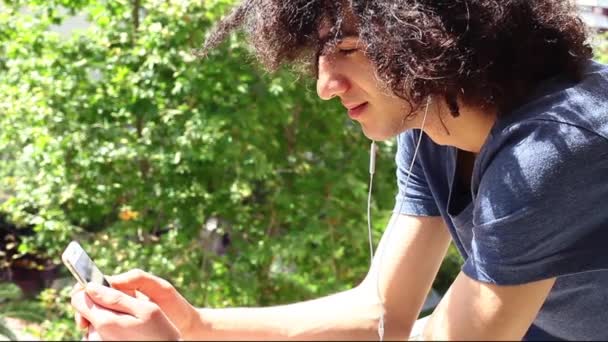 Hombre joven usando teléfono móvil — Vídeos de Stock