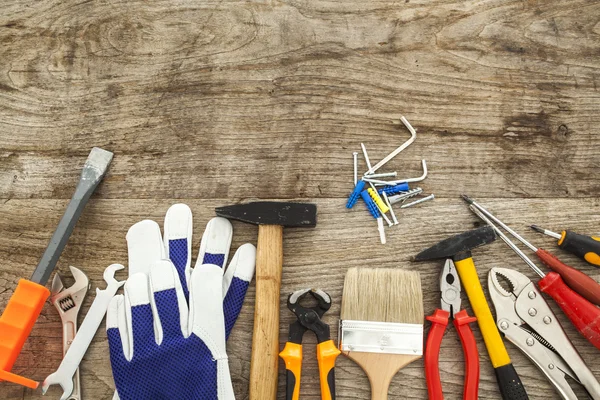 Assorted work tools on wood background — Stock Photo, Image