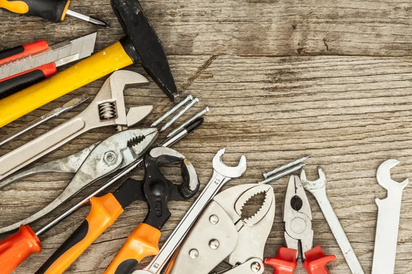 Assorted work tools on wood background — Stock Photo, Image