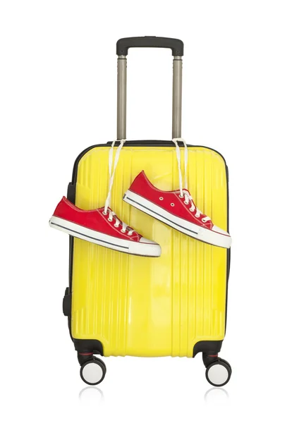 Gelber Koffer mit roten Turnschuhen — Stockfoto