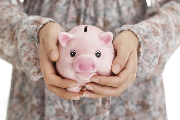 Woman hands holding piggy bank — Stock Photo, Image