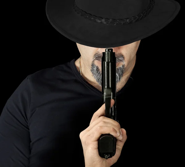 The man in black holding a gun — Stock Photo, Image