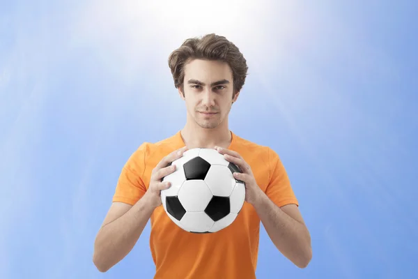 El fútbol sosteniendo una pelota —  Fotos de Stock