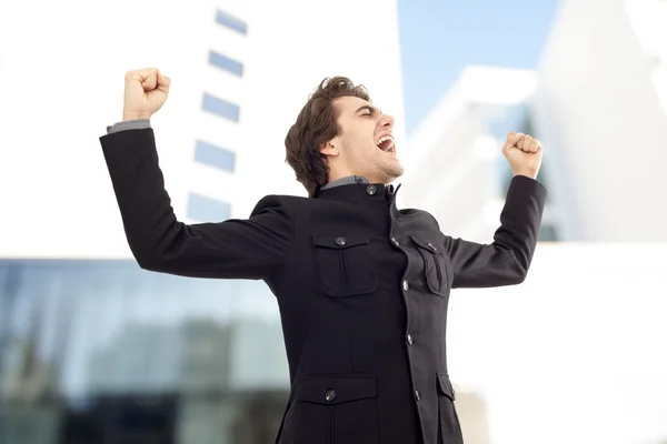 Businessman with arms up celebrating his success — Stock Photo, Image