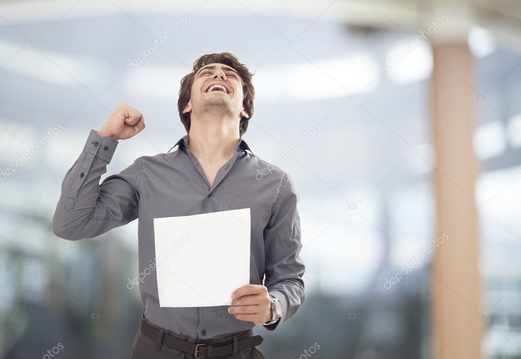 Happy businessman holding the paper