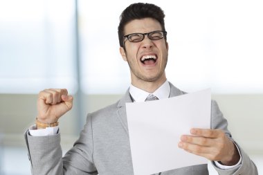 Successful businessman holding the paper