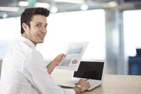 Businessman sitting table and holding document — Stock Photo, Image