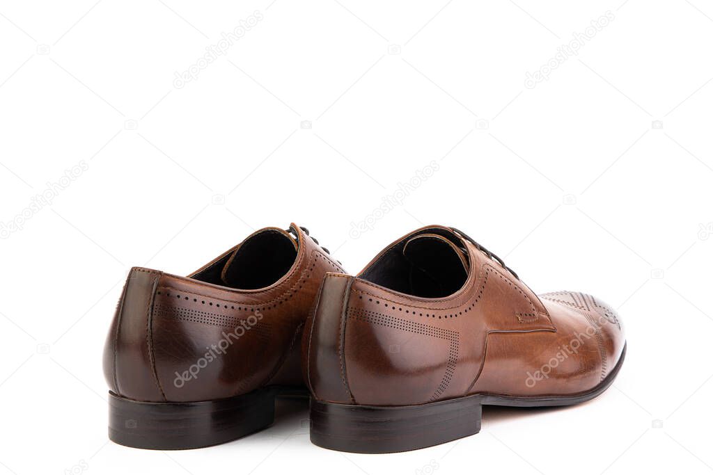 A classic leather elegant brogues men's shoes isolated white background. Groom's stylish brown shoes. Isolated object close up on white background. Back side view.