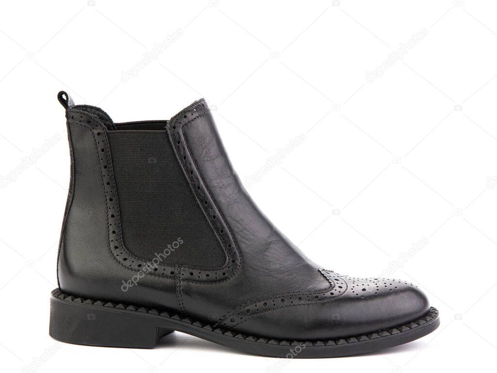 black leather chelsea boots with black elasticated side details, pattern details and black rubber sole. Isolated close-up on white background. Right side view. Fashion shoes.