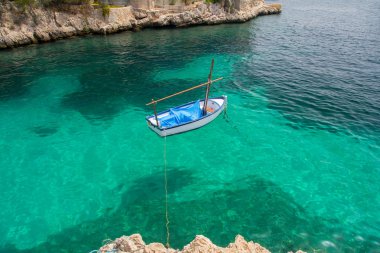 top view of small boat on azure sea clipart