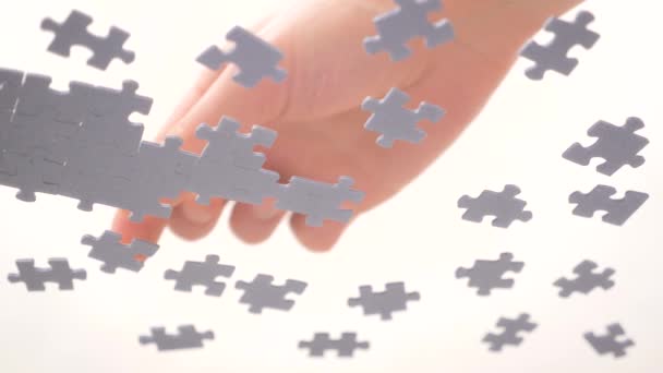Bottom View. Human Hands Assembling Jigsaw Puzzle. Pastime, a hobby. Complex project management. Playing Calm Board Game. Unfinished Jigsaw Puzzle. Finding a Solution. Task and subtask concept — Stock Video