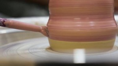 Kil çömlek üzerinde çömlek resmi. El yapımı seramik. Toprak takımı. Çömlekçilik sınıfındaki çömlek atölyesinde boya fırçasıyla seramik kap boyamak. Potter, çanak çömlek boyama işini halleder.