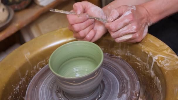 Pottery painting on clay pot. Handmade workshop ceramic. Earthenware. Painting ceramic pot with paint brush in pottery class potter workshop wheel. Potter work hands close up painting pottery making — Stock Video