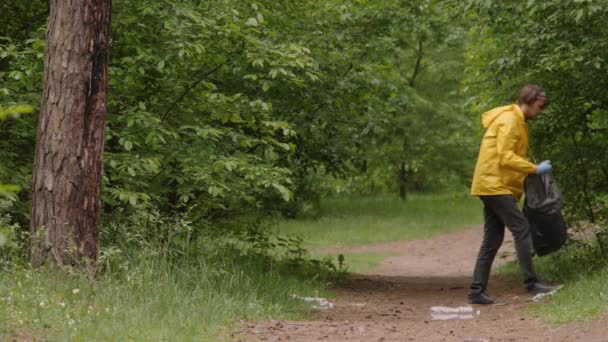 Wolontariuszka zbierająca śmieci w lesie. Wolontariuszka sprząta śmieci w parku. Ekologia zanieczyszczenie odpadów plastikowych. Przyjazny dla środowiska. Chroń naturę. Ochrona środowiska. Bezpieczna natura. Ocal naturę. Ochrona środowiska — Wideo stockowe