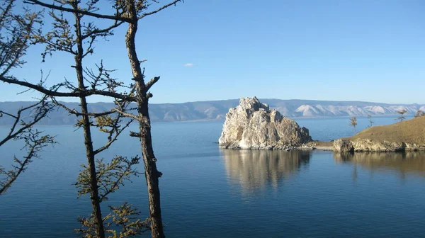 The famous Shamanka Rock is a natural landmark of Olkhon Island on Lake Baikal on an autumn sunny windy afternoon — Stock Photo, Image