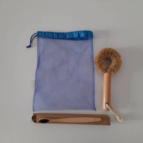 Dish washing brushes, bamboo toothbrushes, reusable bags. Sustainable lifestyle zero waste concept. Clean without waste. No plastic objects.