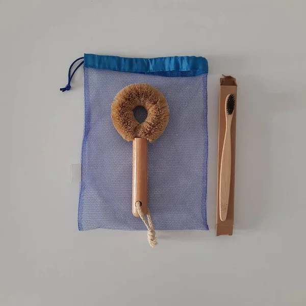 Dish washing brushes, bamboo toothbrushes, reusable bags. Sustainable lifestyle zero waste concept. Clean without waste. No plastic objects.