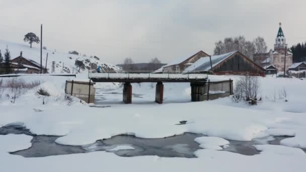 Letecký pohled na snowboard přecházející most v zimě — Stock video