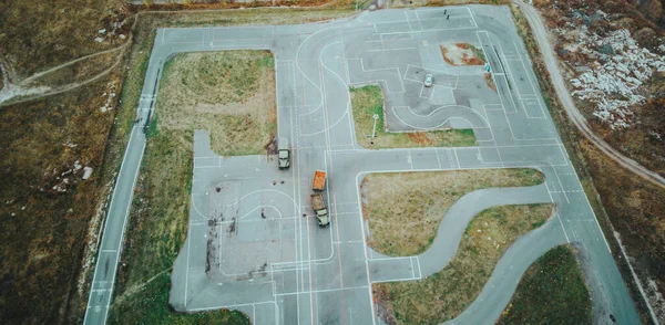 Aerial view of circuit with training cars. Bird\'s eye view of platform for learning car driving
