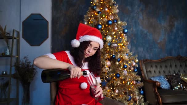 Young Woman Santa Claus Suit Pours Champagne Glass Sitting Chair — Stock Video