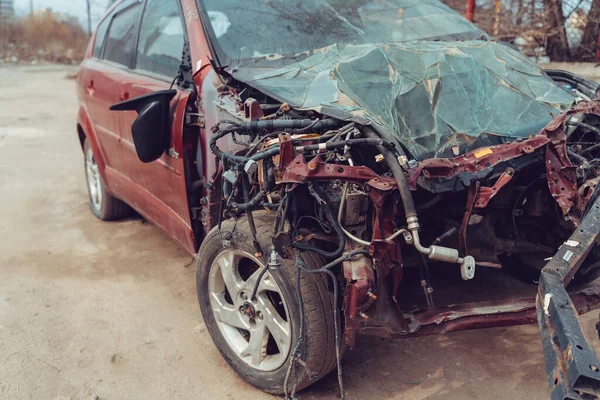 Close up of broken and abandoned car. Smashed car to pieces after accident on street. Concept of careless driving