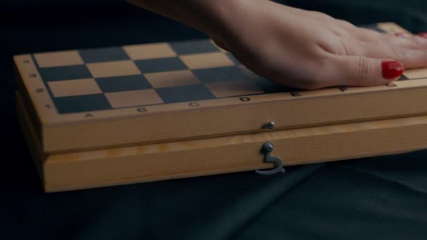 Close Chessboard Black Background Unknown Female Hand Strokes Checkerboard Opens — Αρχείο Βίντεο
