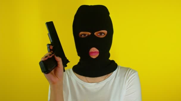 Unrecognizable Woman Black Balaclava Gun Yellow Background Dangerous Criminal Mask — Stock Video