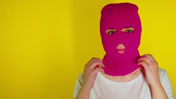 Close Unrecognizable Person Pink Balaclava Yellow Background Young Woman Removes — Stock Video