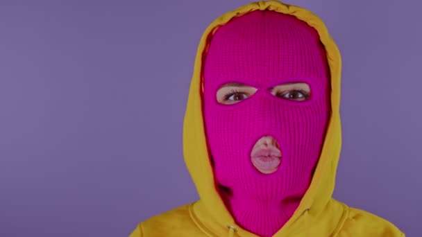 Неузнаваемая Женщина Розовой Балаклаве Посылает Воздушные Поцелуи Фиолетовый Фон Неизвестная — стоковое видео