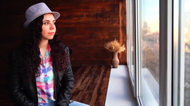 Young Beautiful Woman Hat Leather Jacket Sitting Windows Portrait Pretty — Stock Video