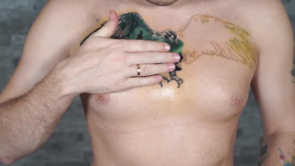 Man Smearing Cream Incomplete Tattoo His Chest Close Men Hand — Stock Video