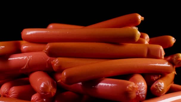 Close Lot Sausages Black Background Swirling Frankfurters Wrapper — Stock Video