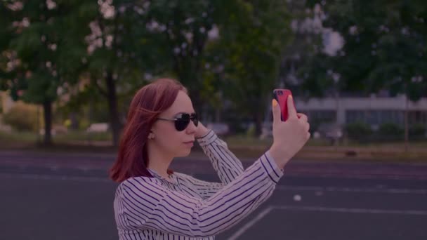 Young Woman Sunglasses Takes Selfie Smartphone Standing City Street Pretty — Stock Video