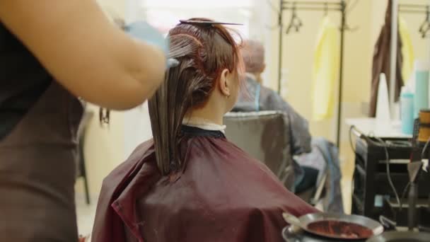 Unrecognizable Person Dyes Hair Young Woman Salon Unknown Hairdresser Gloves — Stock Video