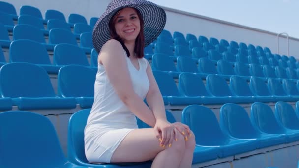 Mujer Joven Vestido Blanco Sombrero Elegante Mira Cámara Sentado Las — Vídeos de Stock