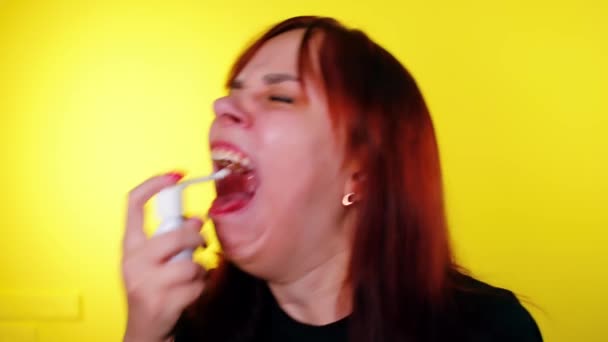 Young Woman Spraying Medicine Throat Mouth Yellow Background Sick Female — Stock Video