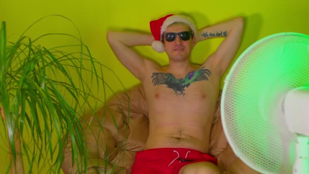 Erwachsener Mann Mit Weihnachtsmütze Und Sonnenbrille Mit Nacktem Oberkörper Sessel — Stockvideo