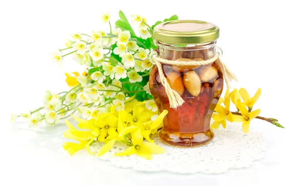 Honey with nuts and flowers — Stock Photo, Image