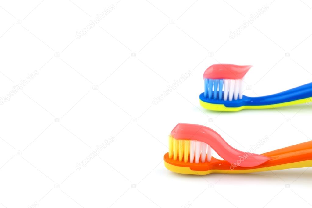 Color toothbrushes with pink toothpaste